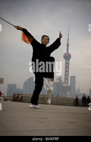 People exercising along the Huang Pu riverfront overlooking the Pudong in Shanghai, China, Asia Stock Photo