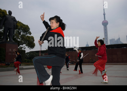 People exercising along the Huang Pu riverfront overlooking the Pudong in Shanghai, China, Asia Stock Photo