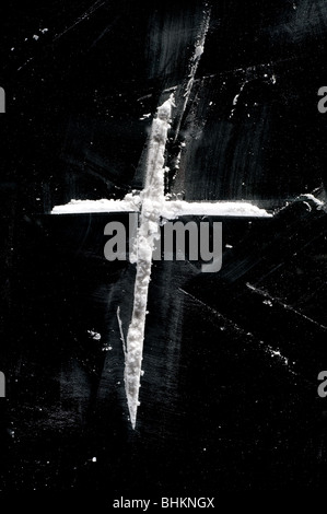 image of lines of cocaine powder in shape of cross on black surface Stock Photo