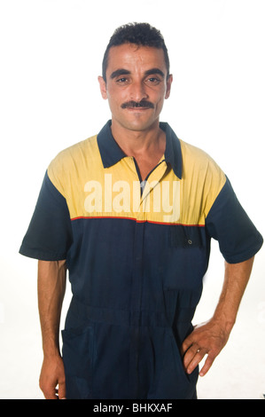 Portrait of a Middle Eastern mechanic in coverall standing hand on hip against a white background Stock Photo