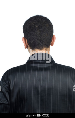 Rear view of a young man standing against a white background Stock Photo