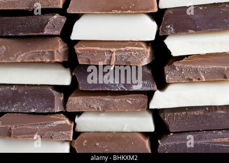 Many flavors of chocolate stacked up Stock Photo