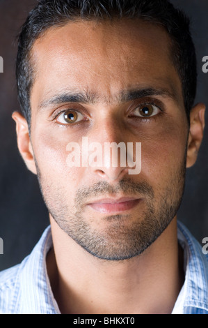Close up portrait of a young Arab man staring at the camera Stock Photo
