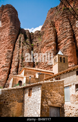 'Las Peñas de Riglos' or 'Mallos de Riglos' rock towers at Riglos, Huesca Province, Aragon, Spain, with Village in foreground Stock Photo