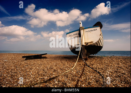 Wooden boat on the shingle beach at Dunwich, Suffolk, England, UK Stock Photo