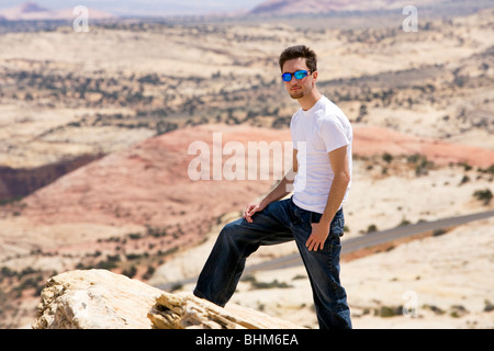 Young Man standing on a Cliff in Utah. Stock Photo