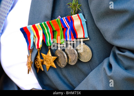 War medals, proudly worn by an older war veteran during an ANZAC Day parade, Australia. Brave military veteran proudly wearing medals on his chest. Stock Photo