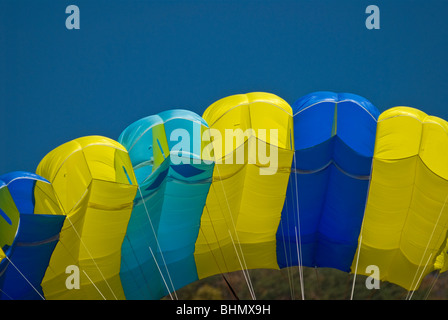 A yellow and blue parachute against a blue sky during Bridge Day at the New River Gorge, Fayetteville, WV. Stock Photo