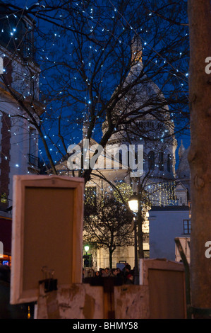 Place du tertre and Sacre coeur at dusk with christmas light in frgd Stock Photo