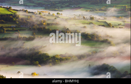 Mist blows over rolling countryside in the early morning near Talybont-on-Usk, Brecon Beacons National Park, Powys, Wales, UK. Stock Photo