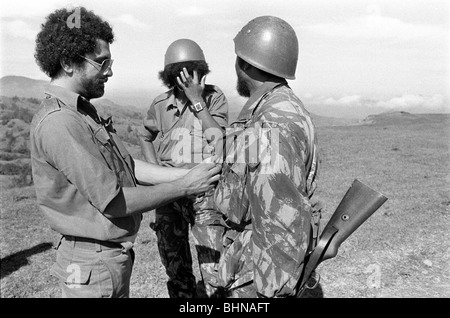 Jose Ramos-Horta fastens Fretilin commander's jacket while defending East Timor against Indonesian incursion in mountains Stock Photo