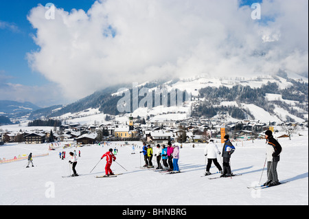 Ski school lesson on the nursery slopes just outside the resort centre, Westendorf, Tyrol, Austria Stock Photo