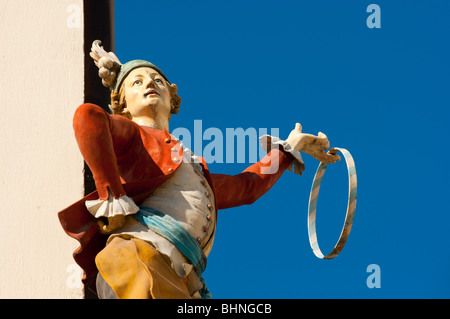 Shop statue of man in traditional German costume, Munich, Germany Stock Photo
