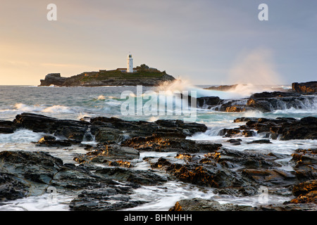 Atlantic waves crashing over the rocks at Godrevy Lighthouse, St Ives Bay Stock Photo