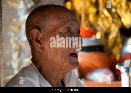 Elderly Buddhist nun at Angkor Wat, Siem Reap, Cambodia Stock Photo