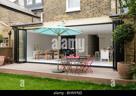Decked patio with parasol of London Victorian townhouse with modern extension Stock Photo