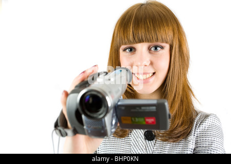 Girl using video camera (camcorder), isolated on white background Stock Photo