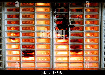 Gas fireplace with a heavy build-up of soot. Stock Photo