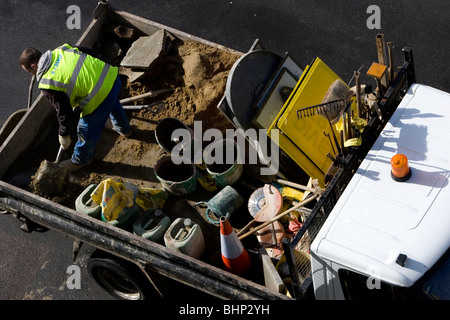 A builder makes cement in the back of a truck in Brunswick Square, Hove, East Sussex. Stock Photo