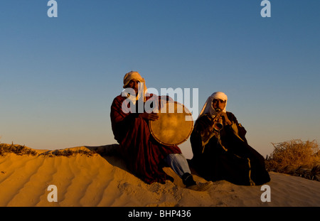 Bedouin men playing music in Sahara desert in Douz Tunisia Africa Stock Photo