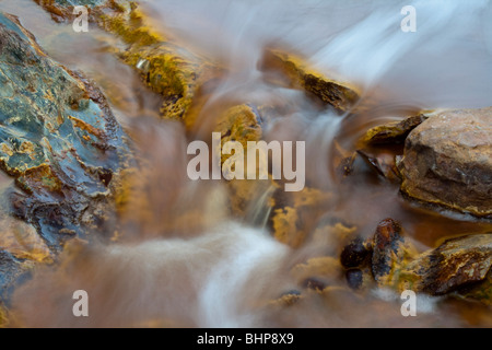 Colourful waterfall in Riotinto, (Rio Tinto) Huelva, Andalucia, Spain. This picture of a river was taken using a long exposure. Stock Photo