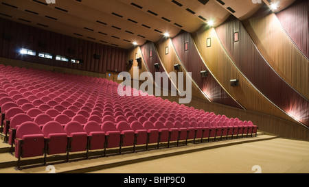 Empty cinema auditorium line of pink chairs. Stock Photo