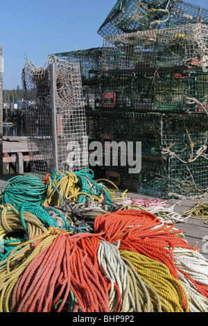 Lobster Traps and colorful pot lines lie about on a pier at Port Clyde Stock Photo