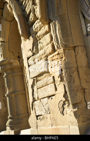 Heavily weathered eroded damaged worn-down sandstone blocks on a building, UK Stock Photo