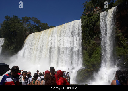 tourists at viewpoint underneath the adan y eva adam and eve fall on the lower circuit in iguazu national park argentina Stock Photo