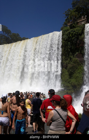 tourists at viewpoint underneath the adan y eva adam and eve fall on the lower circuit in iguazu national park argentina Stock Photo