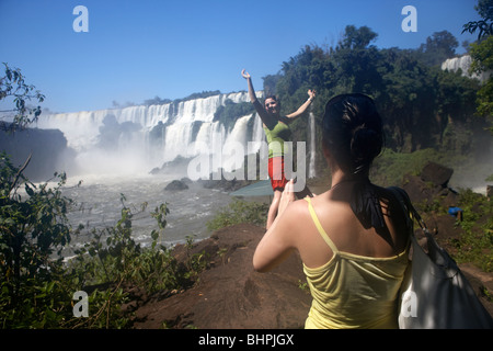 wet female tourists taking photos at iguazu national park, republic of argentina, south america Stock Photo