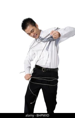Young businessman mockingly pulling a usb cable off his pants