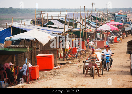 A man driving a Tuk Tuk in a rural village outside Phnom Penh Cambodia Stock Photo