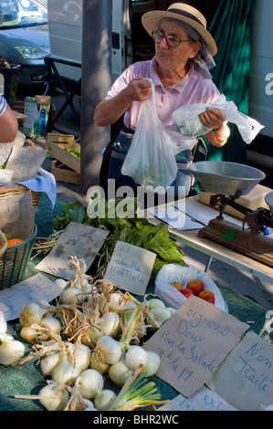 Arles, France -  Woman Clerk, Local Outside, 'Farmers Market'  Female, Selling onions, arles market provence Stock Photo