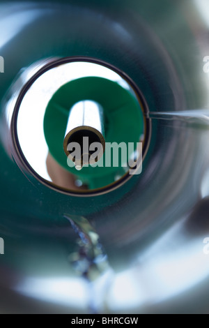 Petrol trickling down a petrol pipe from a pump Stock Photo