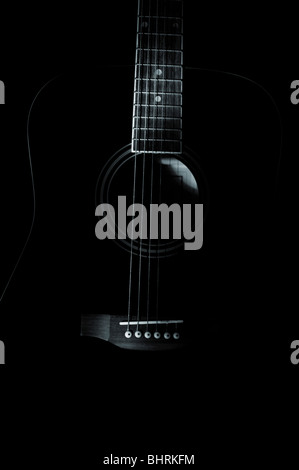 A low light shot of an acoustic guitar Stock Photo