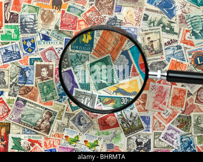 international postage stamps of the world with magnify glass