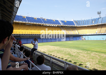tour group with guide in the stand interior of Alberto J Armando la bombonera stadium home to atletico boca juniors Stock Photo