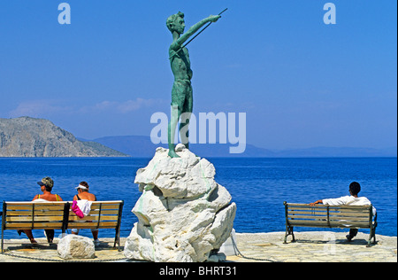 statue of a boy at the harbour entrance of the capital town, Symi Island, Greece Stock Photo