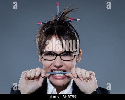 beautiful business woman biting her pencil  on isolated background Stock Photo