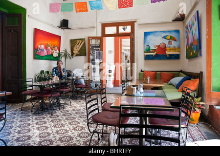 charming  interior of small colorful light filled cafe restaurant  with beautiful old patterned tile floor in Oaxaca City Mexico Stock Photo