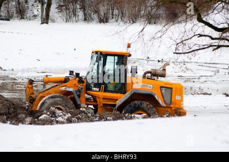 Bulldozer deep in mud and snow Stock Photo