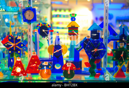 Display of colorful Murano glass clocks in shop window, Venice, Italy Stock Photo