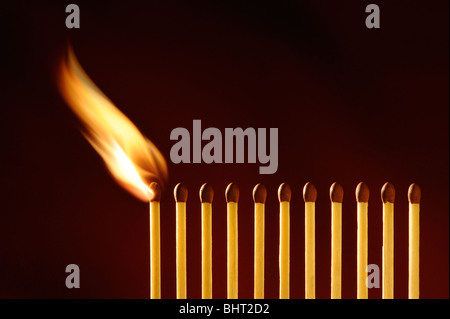 A line of matches igniting Stock Photo