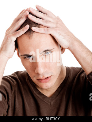 Stressed young man with a headache isolated on white Stock Photo