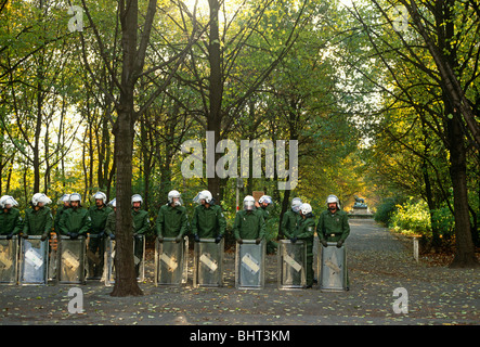 Awaiting the call-up from superior officers, a phalanx of German riot police stand in their ranks, with shields on the ground. Stock Photo