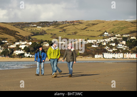 Winter afternoon, People walking on the beach Dyfi Ynyslas national nature reserve, near Borth, Ceredigion, Wales UK Stock Photo