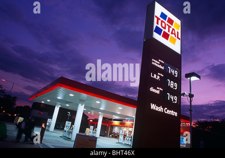 Seen at a slight angle, a Total petrol filling station is seen in early evening while there is still detail in the fading sky. Stock Photo
