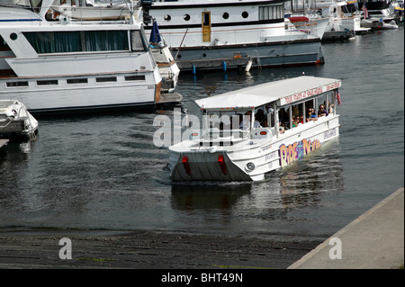 Second world War Amphibious vehicle emerges from lake Union, during a Duck tour of Seattle Stock Photo