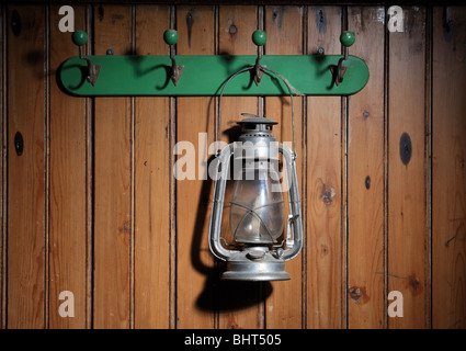 antique lantern hanging on coat rack Stock Photo